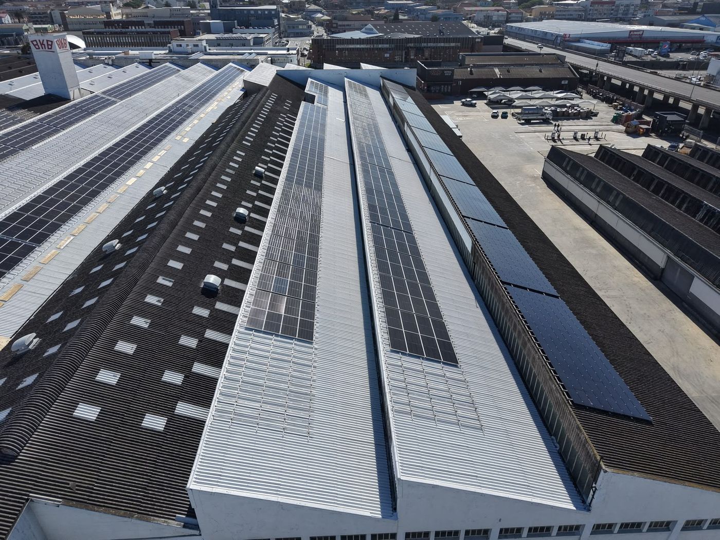 Sawtooth factory roofs sealed white around solar panels