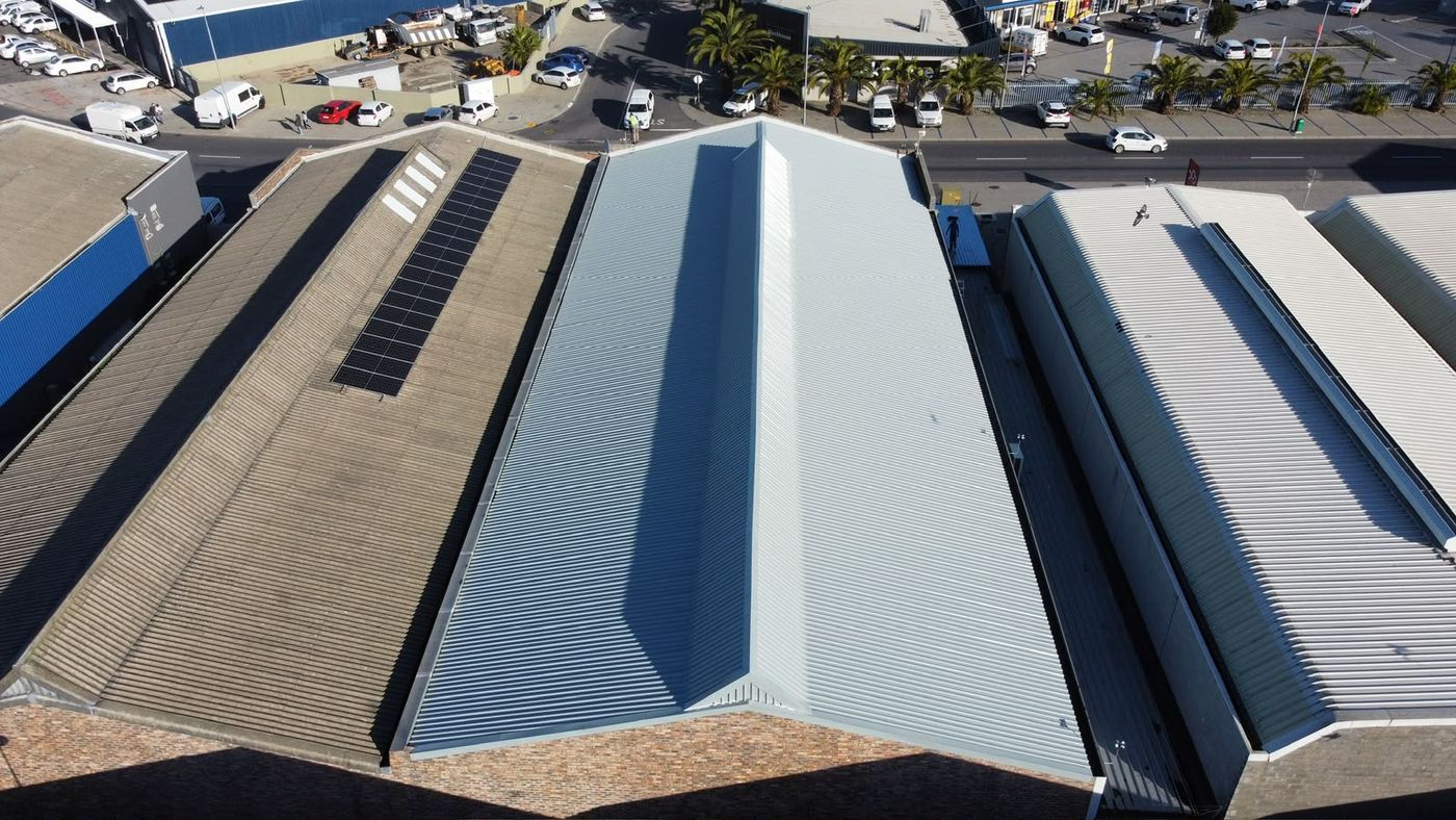 Warehouse roof sealed by Cape Asbestos Solutions next to an older asbestos roof